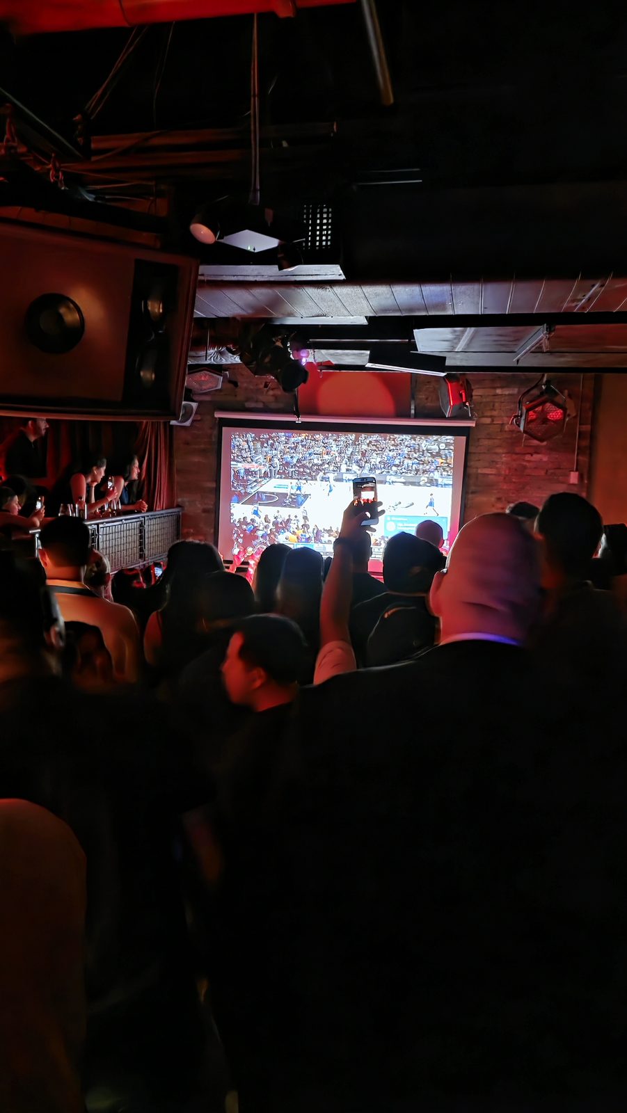 Projector screen at a restaurant event with guests watching
