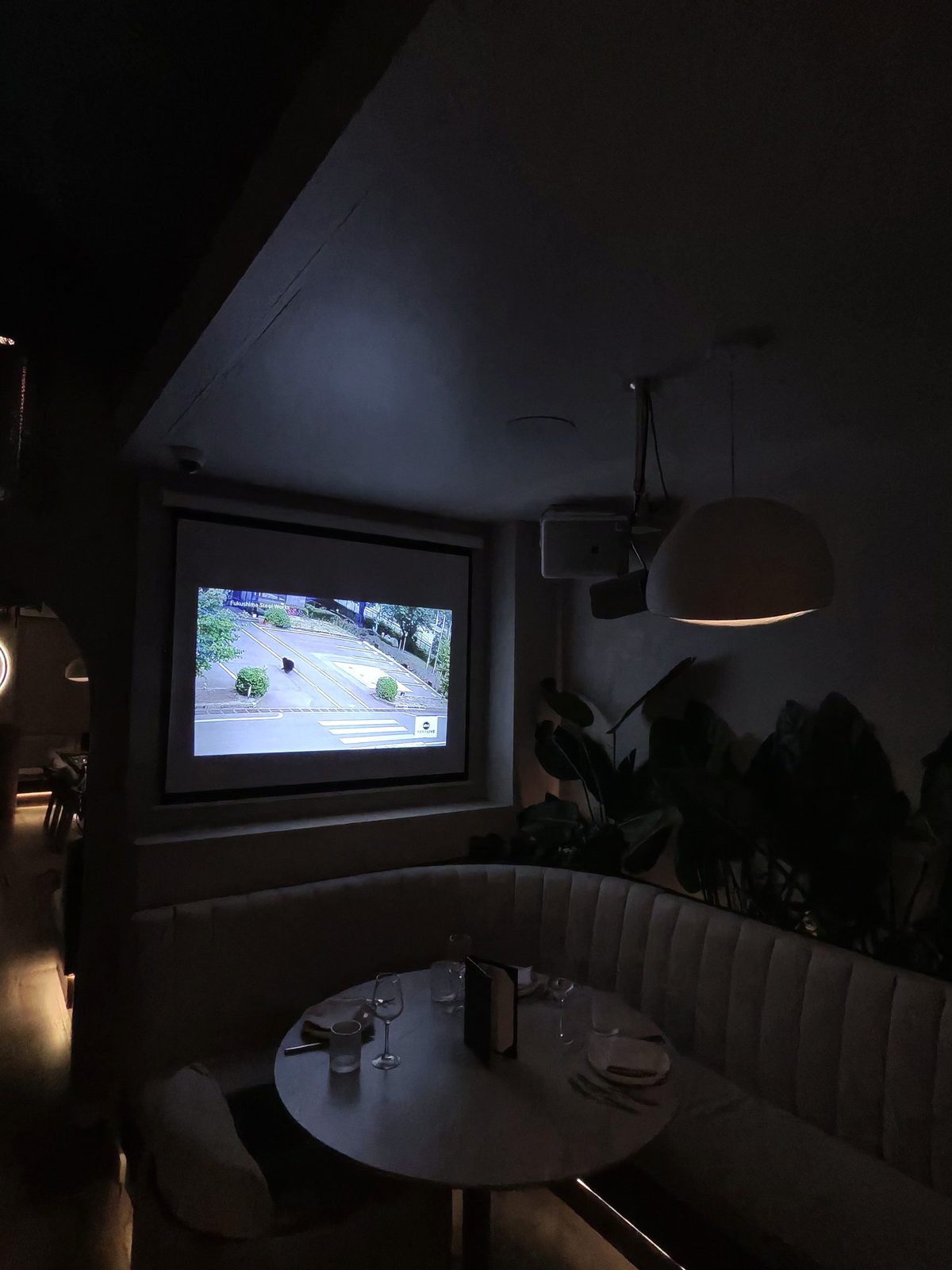 Projector screen mounted in a modern restaurant dining room